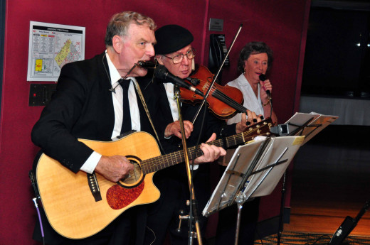 Volunteer Trio playing to welcome guests into a venue where a great evening of entertainment was provided.  