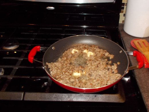 Next, melt butter into the browned sausage. 