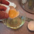 4. Pull apart the halves allowing the white to fall into the container and the yolk to remain in the shell. This takes a little practice. To remove the rest of the egg white, gently pour the yolk into the other half of the egg shell 4. Pull apart the halves allowing the white to fall into the container and the yolk to remain in the shell. This takes a little practice. To remove the rest of the egg white, gently pour the yolk into the other half of the egg shell