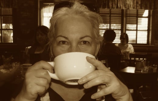 the author enjoying her cup of coffee