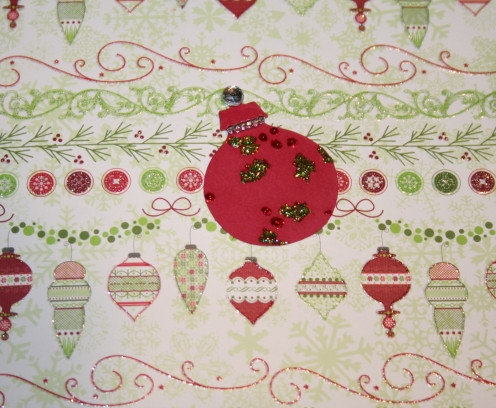I colored the embossed images of holly berries with glitter glue.  