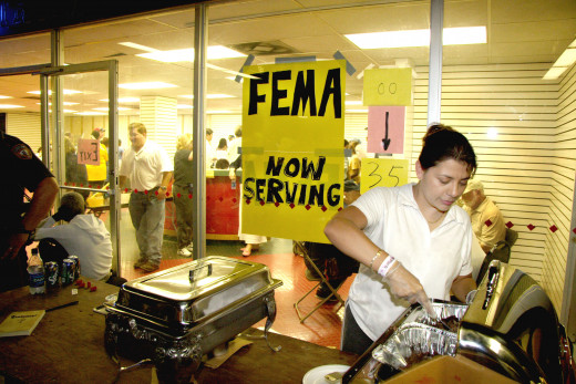 A volunteer serves hot meals to evacuees as they wait to register with FEMA at the Houston Astrodome. Thousands of people displaced by Hurricane Katrina are being housed in the Astrodome.