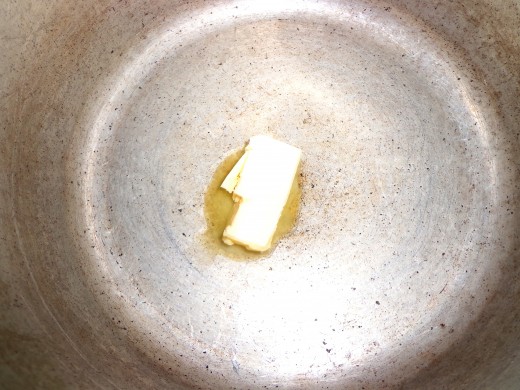 Add butter inside the cooker and heat it