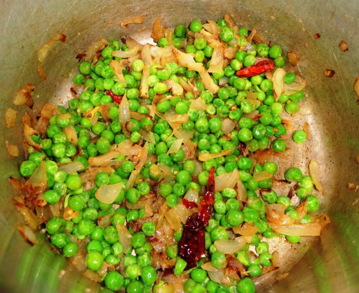 Red chilies and green peas is added inside for sauting
