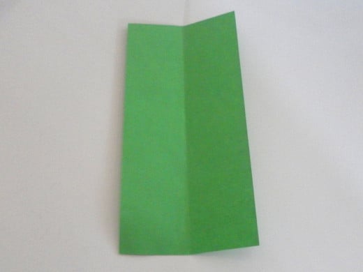 Unfold the paper. You should see a vertical line in the middle.
