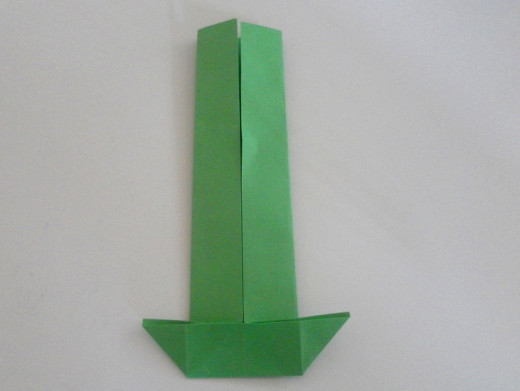Pull out the corners of the paper to form this shape like an upside down roof.