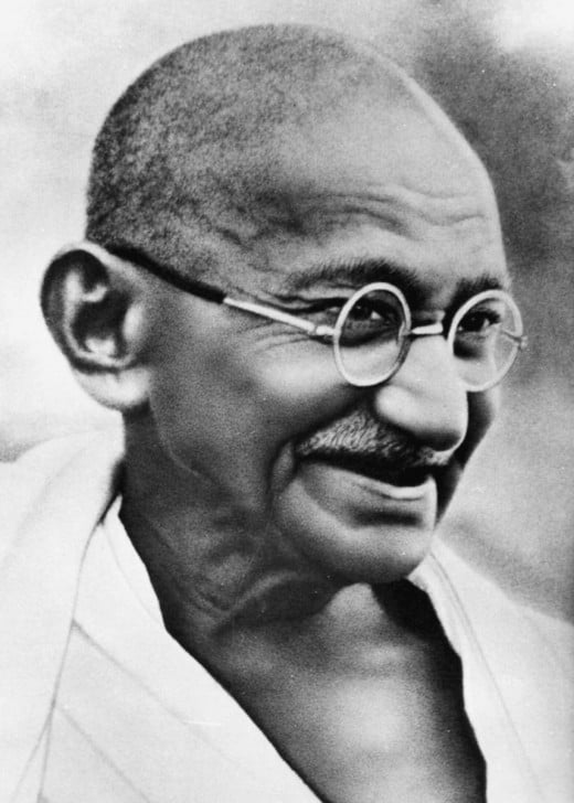 A smiling close up photograph of Gandhi