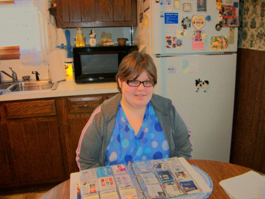 My friend Hannah shows me her method of organizing her coupons using a baseball collecters  book