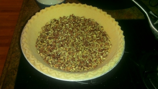 pour finely chopped pecans into the bottom of the pie crust.  After pouring in the pie filling, these will mingle and float around and help with overall consistency of the pie.