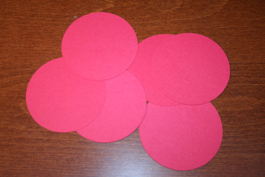 I cut out six circles from two sheets of red cardstock.  Four circles per sheet.