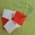 Use sticky tape to hold the paper down. Attach a string to the origami ornament for hanging. Use sticky tape to hold the paper down. Attach a string to the origami ornament for hanging.