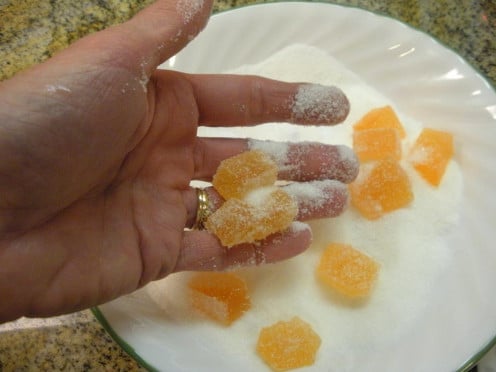 Turn the cut candies into a bowl of granulated sugar and roll them around to coat all sides