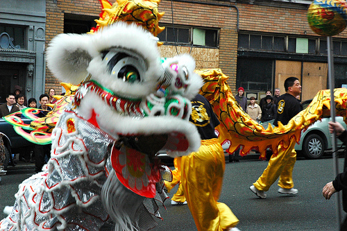 Dancing with a dragon at a Chinese New Year parade.