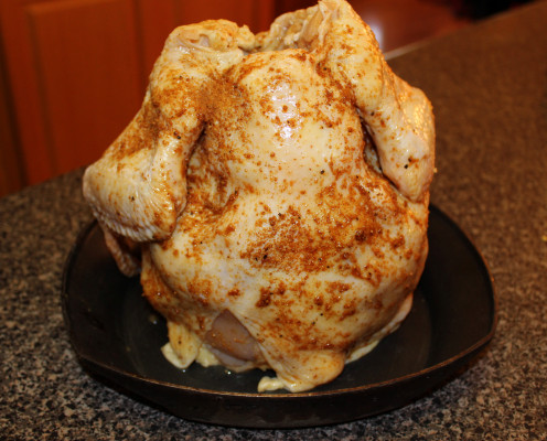 Make sure the chicken is securely on the roaster before placing it on the grill.