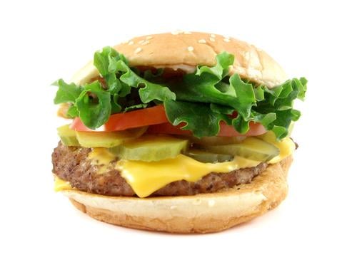 How about a burger with salad and cheese? You've got the meat which contains iron, salad  with tomatoes which contain iron, and Cheese with dairy for calcium. Delicious, not fattening and very healthy!
