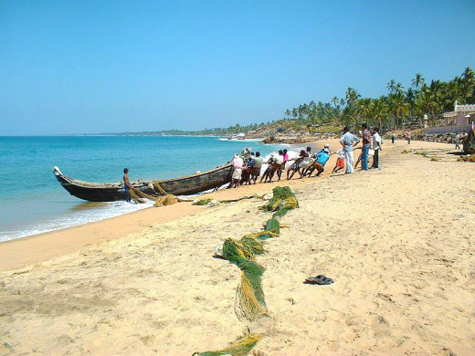 Fishermen Busy At Work Along The Kovalam Samudra Beach.