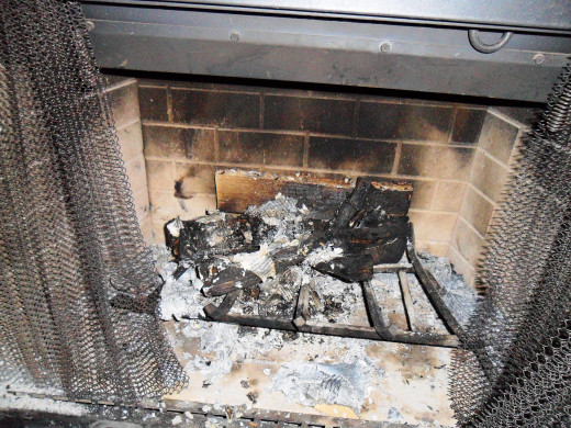 Clean out old, unburned logs and thick layer of ash from the bottom. Your fire needs oxygen to burn well and that oxygen needs to come from the bottom as well as the top.