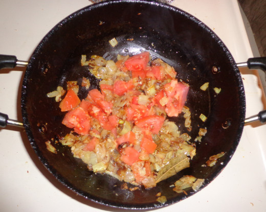 Chopped tomatoes are added in the pan