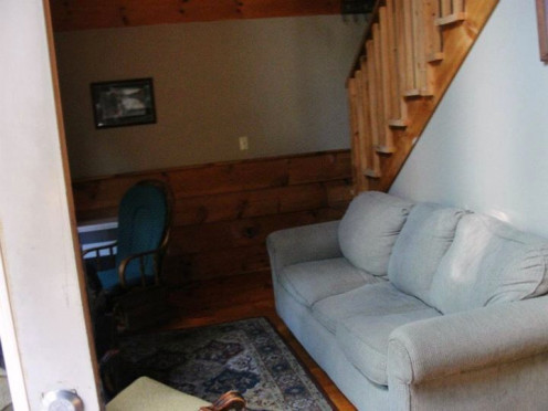 The living room of our Lakeside Cabin. Those stairs lead up to the loft.  That is the main door just to the left.
