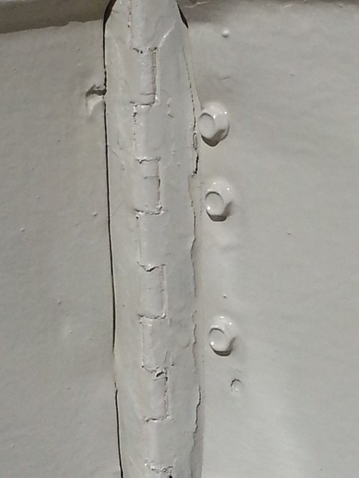 I took my time prepping this hinge.  And took my time painting it.  I let thinner coats dry and bake a bit in hot sun, for a couple days between coats.  What appears to be a fine and uneaven edge??? IS... an un-even and rusted edge of well worn metal