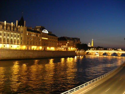 The River Seine in Paris at night, with the Eiffel Tower in the background