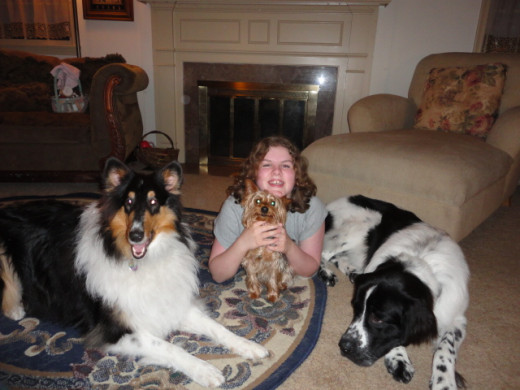 My daughter with her dog family; they have helped her learn compassion, responsibility and how to love without end.