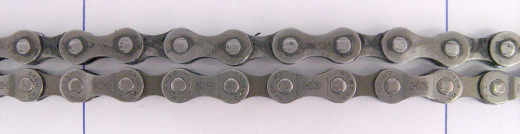 A worn out chain (top) next to a new one (bottom). Note how the worn chain has been stretched over time. 