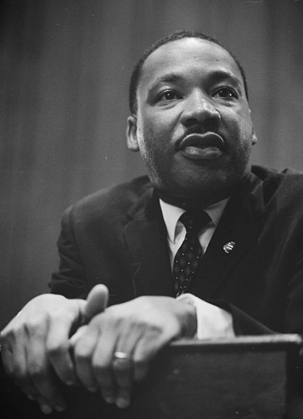 Martin Luther King Jr. - Leaning on a lectern in 1964.  Photo taken by Trikosko, Marion S., and in the public domain.