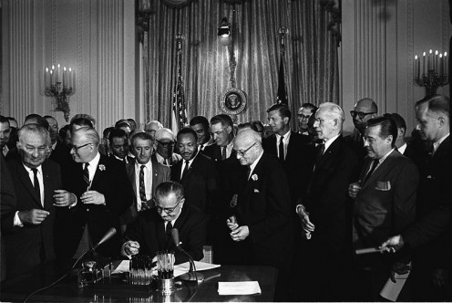 A neat image of the signing of the 1964 Civil Rights Act.  Lyndon B. Johnson and others are looking on. Photo by Cecil Stoughton, White House Press Office (WHPO) and in the public domain.