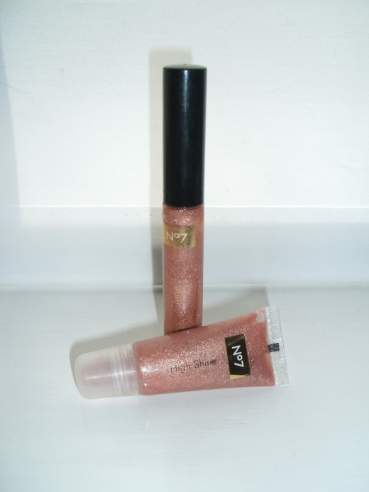 Lip gloss with a warm tint and a golden shine