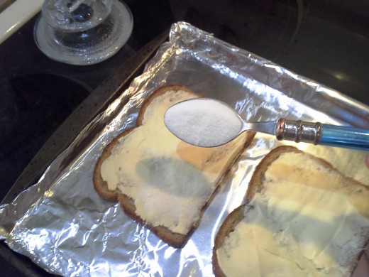 Step Four: With a large spoon, shake a thick layer of sugar onto each piece