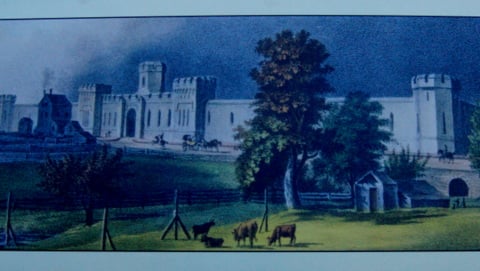 Photograph of a painting on display at ESP.   Painting portrays the prison as it appeared around 1830.