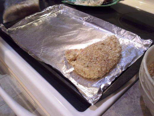 Step Twenty-one: Lay your coated chicken breasts evenly spaced out on your cookie sheet