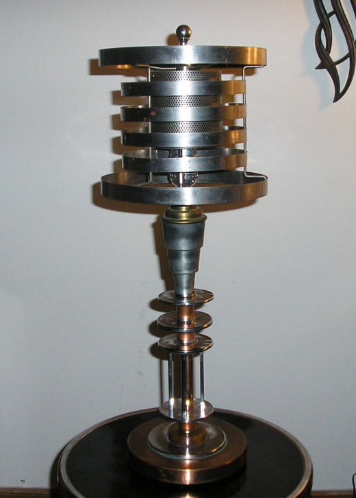A prime example of an American Machine Age product, Brooklyn, NY 1930s.  The Machine Age is an off-shoot movement of the Art Deco Period.  I bought the base piece for $45 added the metal shade (my design)...sold to a Japanese dealer for $975.00