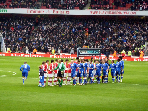 Players of Arsenal F.C. and Everton F.C. shaking hands before a Barclays Premier League match at the Emirates Stadium.
