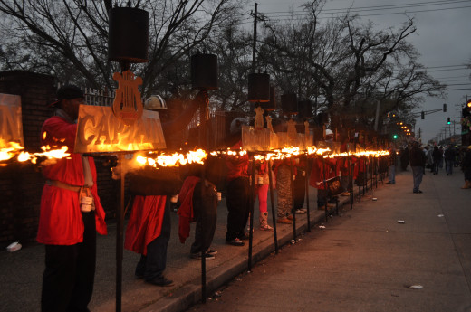 All the flambeaux alight. These are traditional for night parades from before there were streetlights to show the way