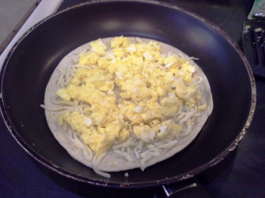 Step Eleven: Spread out your egg and cook to melt your cheese