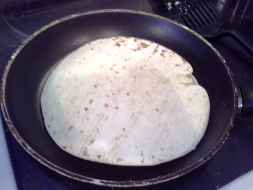 Step Thirteen: Top the whole thing with another tortilla and press down to seal