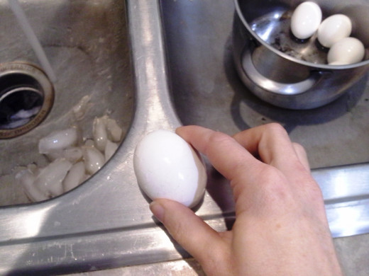 Step Eight: Crack each egg on the side of the sink, making sure to crack the shell all the way around
