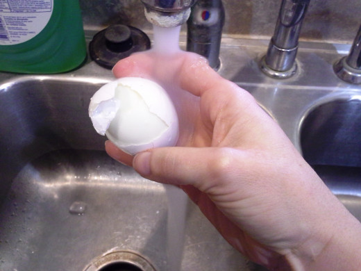 Step Nine: Let cold water run over the top of your egg as you peel the shell away