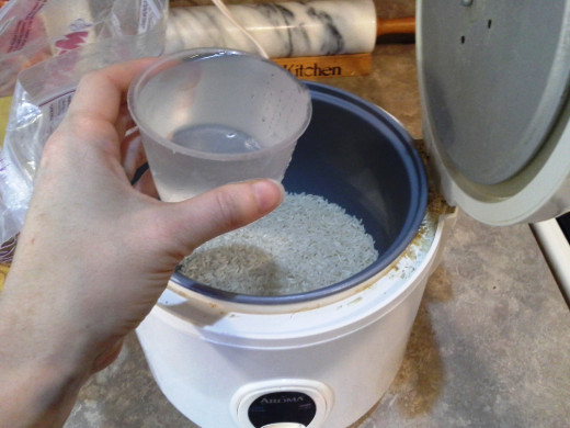 Step Two: For each cup of rice, the package suggests 1 1/2 cups of water, but we always put a little extra