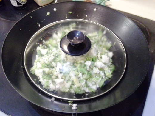 Step Twenty-six: Veggies take a little while to cook, so cover them with the lid of a pot to essentially steam them