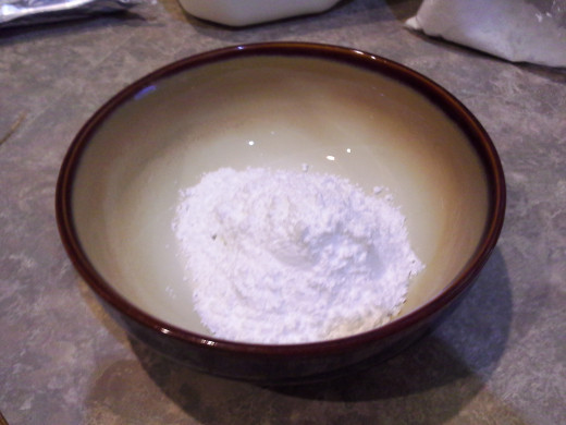 Step Four: Add in your powdered sugar; It looks like too much but it will mix in with some elbow grease