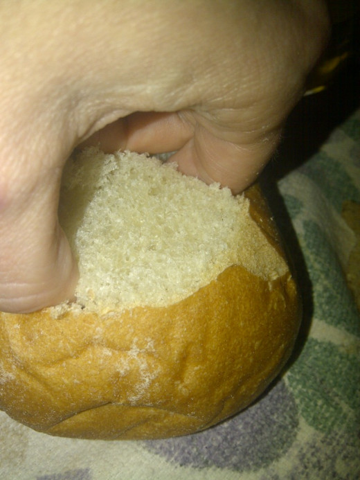 Using clean fingers, pull out bread plug from center of bun.  It will roughly tear out according to depth of knife's cut.