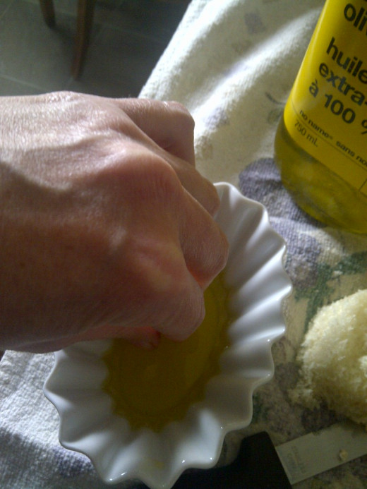dip your fingers and thumb into the olive oil, don't shake off any excess, you'll need as much as your fingers can hold.