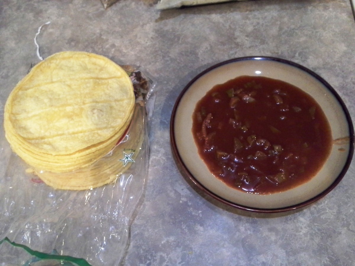 Step Thirteen: Set up your assembly line with your stack of corn tortillas and a small plate of my Homemade Red Enchilada Sauce