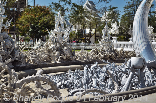 Among the hands reaching out for you are ghoulish heads that seem more comical than scary.  Location: Wat Rong Khun (The White Temple)