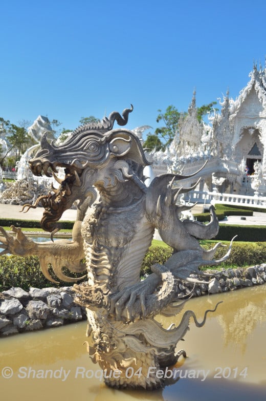 Although it looks cool, it's quite difficult to interpret what this monster symbolizes. Could it be a demon making its way out of hell?  Location: Wat Rong Khun (The White Temple)