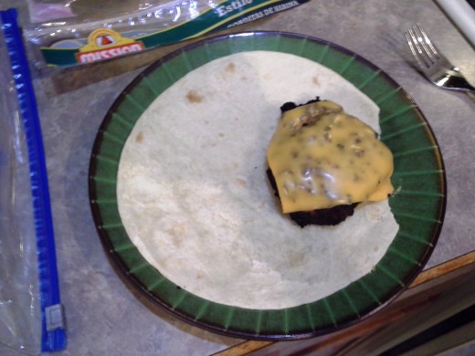 Step Twelve: Place a cooked cheeseburger onto half of your tortilla