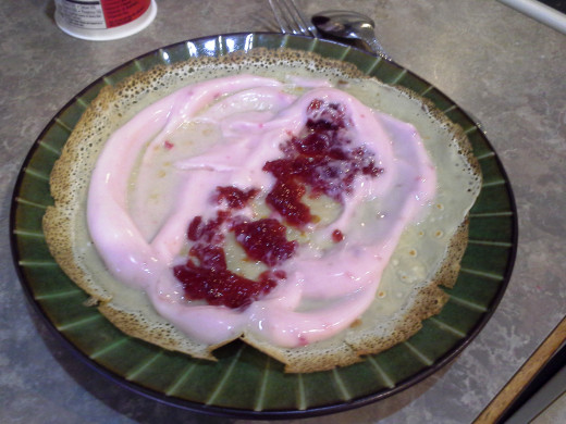 Step Twenty-one: I suggest adding yogurt to the entire surface of your crepe and then adding preserves down the middle